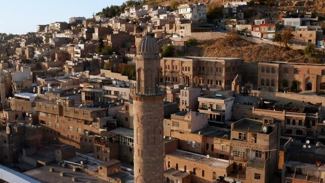 Great Mosque Minaret In The City Of Mardin Nestled On Rocky Hills At Sunset In Turkey. Aerial, Closeup