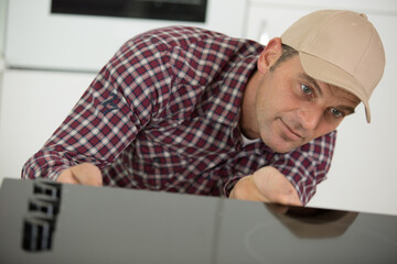 mature man installing a hob