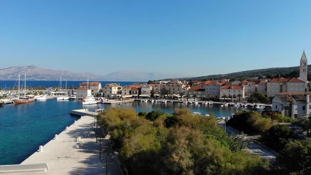 Supetar harbor, aerial lift with pan.