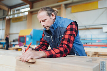 Close up on a male carpenter working in a factory