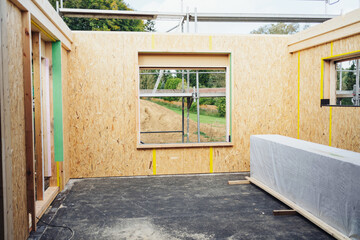 Interior of a roofless timber house under construction