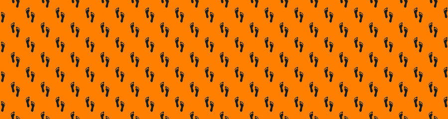 Fototapeta premium a trace of a man on an orange background. seamless pattern of images of a human footprint on an orange background. Banner for insertion into site.3d rendering.3d image.
