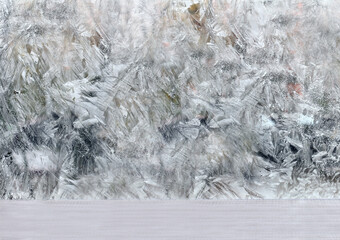 frozen window with frosty patterns. winter background