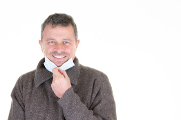 smiling happy man takes off his mask stop covid-19 infection fabric protection isolated over white background