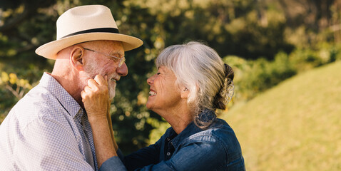 Elderly couple smiling at each other and expressing their love © Jacob Lund