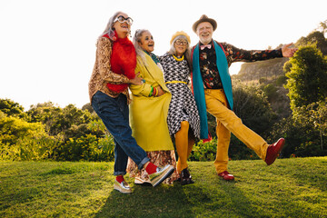 Carefree senior citizens having fun together in a park