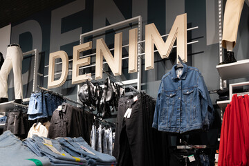 shop interior during sale of stylish trendy denim clothing for youth