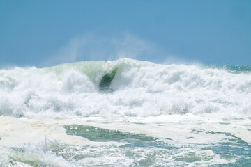 Turquoise curl in breaking waves on Main Beach Mount maunganui, New Zealand. 