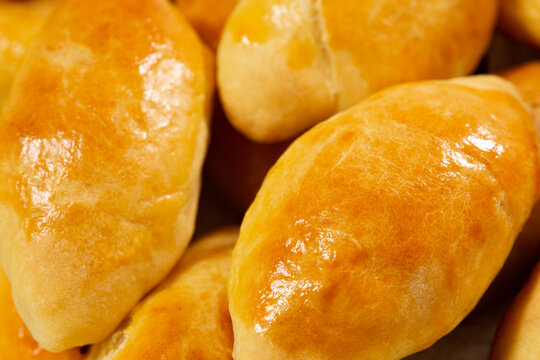 Traditional turkish breakfast savory pastry food close-up top view. It is known as Poaca or Poğa&ccedil;a in Turkish. It is a very popular breakfast food. Cheese, olives, sausage can be put inside.