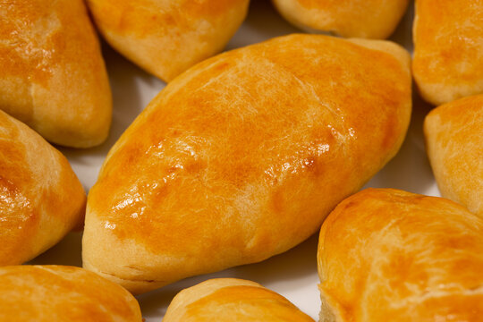 Traditional turkish breakfast savory pastry food close-up top view. It is known as Poaca or Poğa&ccedil;a in Turkish. It is a very popular breakfast food. Cheese, olives, sausage can be put inside.