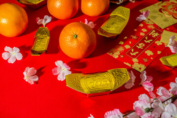 Flat lay mockup for holiday Chinese new year red packet and gold accessories blossom and Lunar...