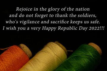 Happy republic day message greeting with tricolour spools of thread