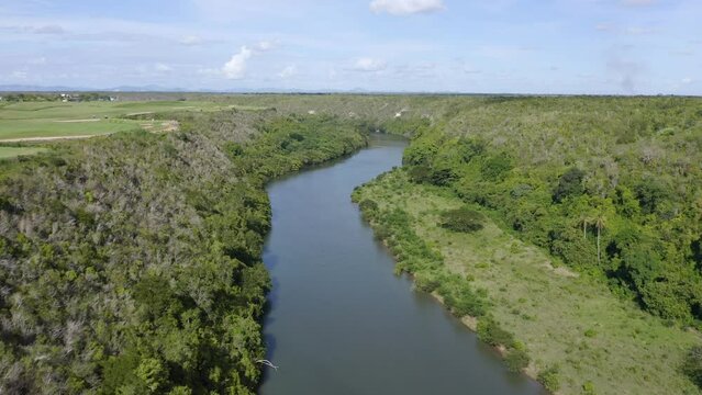 Aerial flyover Chavon River located to the east of the Dominican Republic at sun
