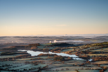 Panoramic view of Tittesworth Reservoir from The Roaches, with the Long Mynd, and The Wrekin in the distance at sunrise in the Peak District National Park, UK.