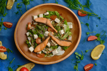 salad with vegetables and herbs and red fish