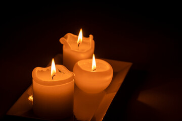 Obraz na płótnie Canvas three burning candles, Mallorca, Balearic Islands, Spain