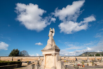 winged angel surrounded by white clouds, Llucmajor cemetery, Mallorca, Balearic Islands, Spain