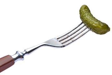 Tasty canned Whole green cornichon on a fork isolated on a white background