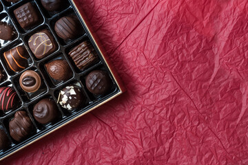 Assorted Luxury Chocolate Box on Red Background, Copy Space