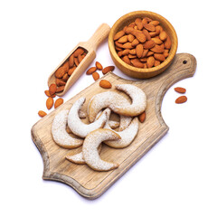 German or Austrian Vanillekipferl vanilla kipferl cookies and almond nuts on wooden serving board