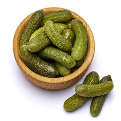 Bowl of Tasty canned Whole green cornichons isolated on a white background