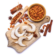 German or Austrian Vanillekipferl vanilla kipferl cookies and almond nuts on wooden serving board