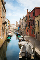 Fototapeta na wymiar Small canal between houses in Venice