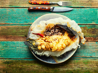 Fried sea bass with wild rice.