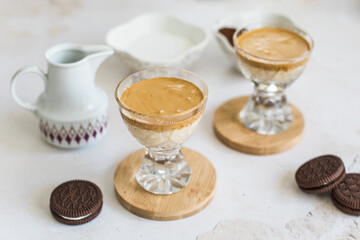 Whipped Dalgona coffee drink in a cup with milk, top view
