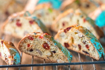 Homemade cookies with nuts, cranberries, cherries and candied fruits on wood background