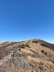 한국 소백산 정상과 능선, 억새 풍경, 등산하는 여자 /  The summit of Sobaeksan Mountain in Korea, ridges, silver grass scenery, and a woman hiking 