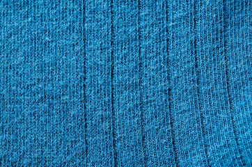 Blue knitted carpet close up. Textile texture detailed warm yarn.