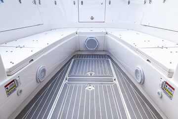 Fototapeta premium Part of the yacht's teak deck with closed escape hatches to the yacht's cabins and acoustic speakers built into the boat's hull.
