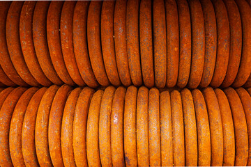 Stacked to each other rusty steel rings for securing loads, top view. Crusher rollers.