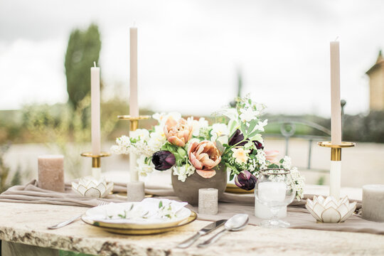Romantic dinning table in backyard, decorated with flowers for intimate wedding 