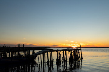 Fototapeta na wymiar sunset at Comporta wooden pier in Portugal 