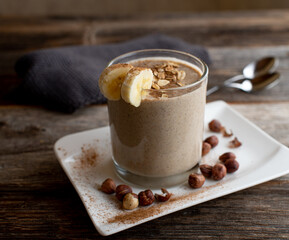 Protein smoothie with chocolate whey, banana, oats, hazelnuts and cinnamon