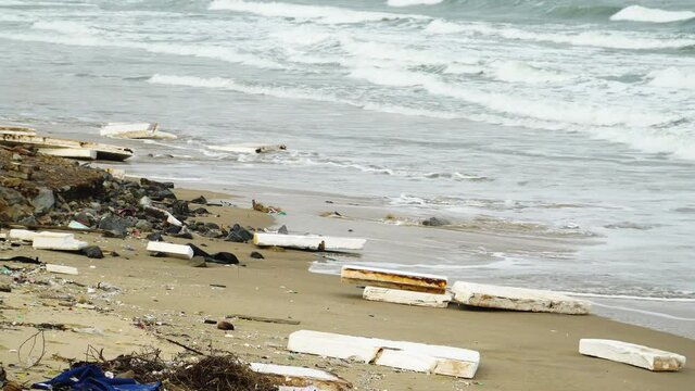 Gimbal shot of closed cell extruded polystyrene foam thrown on beach