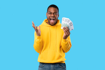 Emotional Black Man Shouting Holding Euro Money Over Blue Background
