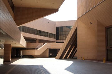 Interplay of Light and Shadow on Empty Plaza surrounding by Geometrical Modern Architecture