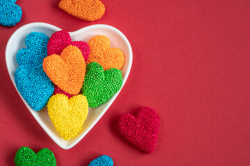 heart shaped candy sweets on red background