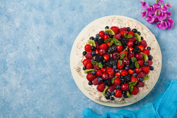 Meringue Pavlova cake with fresh fruit. Top view.