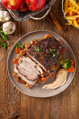 Whole roasted pork neck, stewed in wine with vegetables.
