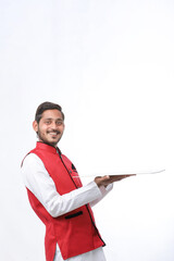 young indian man in traditional wear and giving expression on white background.