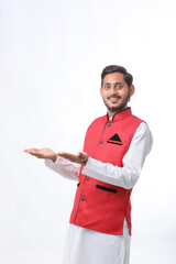 young indian man in traditional wear and giving expression on white background.