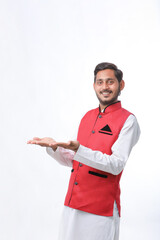young indian man in traditional wear and giving expression on white background.