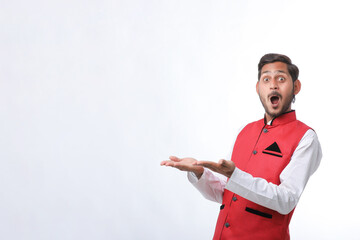 Young indian farmer in traditional wear and giving expression on white background.