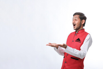 Young indian farmer in traditional wear and giving expression on white background.