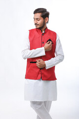 Young indian farmer in traditional wear and giving expression on white background.