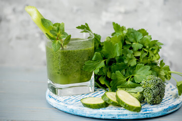 Green vitamin drink from vegetables and different green vegetables.